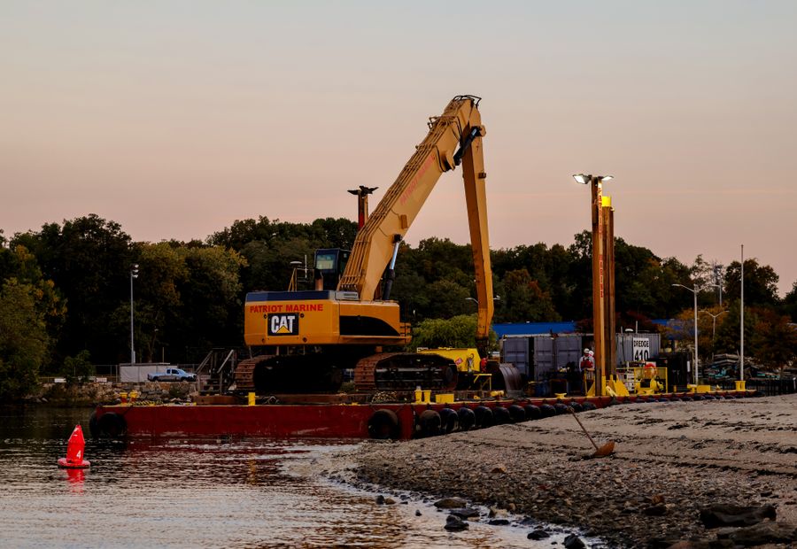 Barge rig driving new sheet pile for a replacement bulkhead on a Hampton Roads river