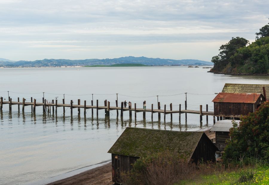 Timber pier on pilings over a calm Hampton Roads tidal river